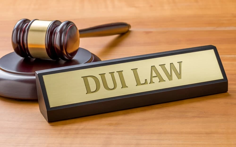 Image is of a gavel placed beside a DUI law nameplate, concept of a DUI lawyer handling legal cases